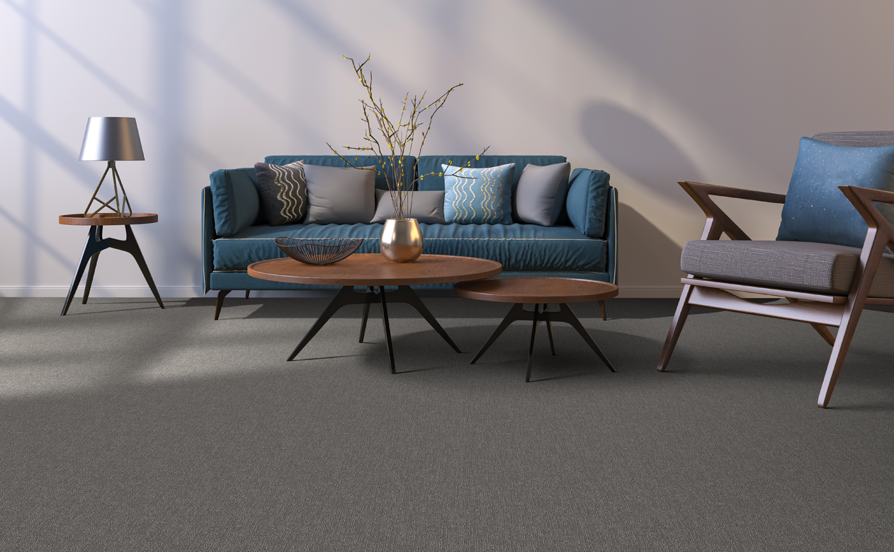 brown carpet in living room with dark blue velvet sofa and brown coffee tables